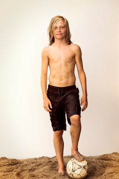 Portrait of boy (12-13) standing on beach 