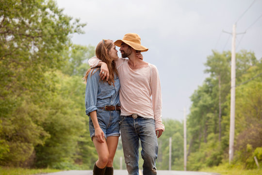 Couple face to face on country road 