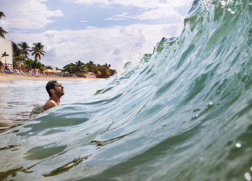 Mid-adult man looking at wave 