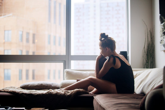 Young woman sitting on sofa 