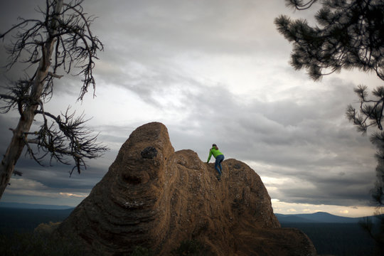 Woman climbing on rock  