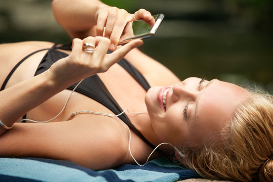 Young woman listening to mp3 player 