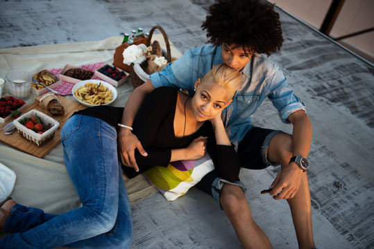 Portrait of young woman with her boyfriend on roof 