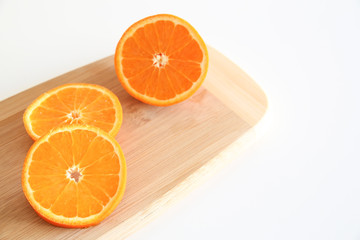 Fresh Oranges on a Wooden board. White background.