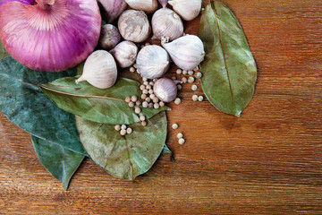 garlic ,white pepper and red onion on wood table