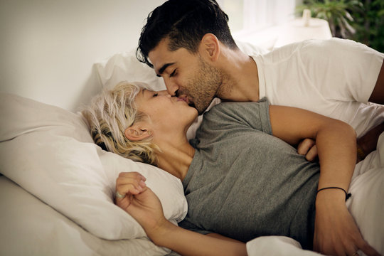 Young couple kissing in bed 