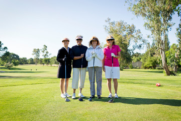 Portrait of four female golfers on golfcourse 