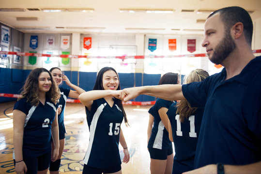 Team of volleyball players in sports hall 