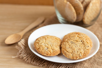 Oat cookies are homemade on the plate on sackcloth. Its are a nutrient-rich food associated with protein and fiber.