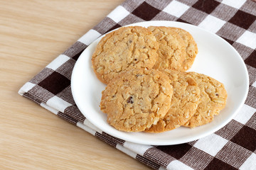 Oat cookies are homemade on the plate on cloth. Its are a nutrient-rich food associated with protein and fiber.