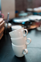 white coffee mugs stacked in mini cafe