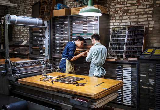 Men working in print workshop 
