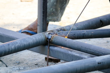 Taking close-up shots, the mechanic is welding the steel roof.