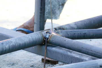 Taking close-up shots, the mechanic is welding the steel roof.