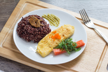 Rice with omelette on plate