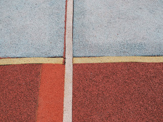 An empty of outdoor colorful basketball court in hongkong. Pole aerial image including of pavement crack, red key, yellow lines. health concept