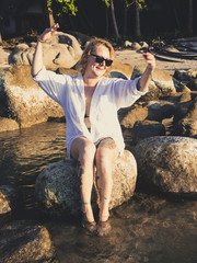 Woman enjoying the beach in summer. Sunset in Koh Tao,  Thailand