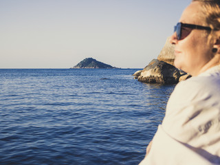 Woman enjoying the beach in summer. Sunset in Koh Tao,  Thailand