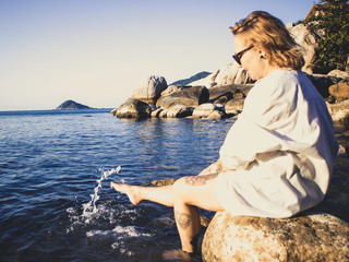 Woman enjoying the beach in summer. Sunset in Koh Tao,  Thailand
