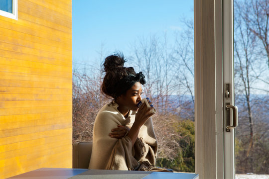 Young woman drinking tea in living room 
