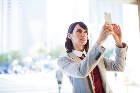 Portrait of woman taking photo 