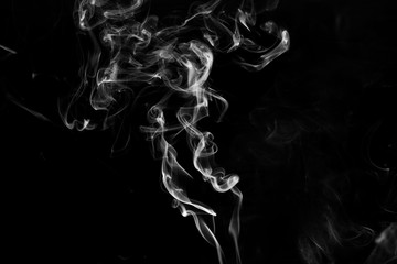 Smoke the white incense on a black background. darkness concept