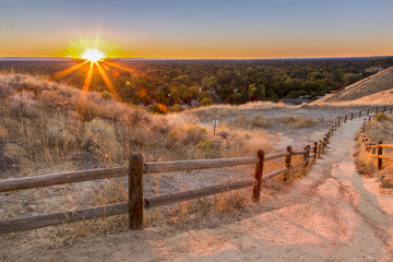 Downhill foothills trail in Boise, Idaho at sunset - obrazy, fototapety, plakaty