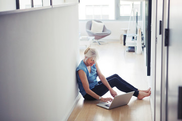Senior woman using laptop at home 