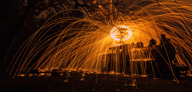 steel wool on top of a train at night - Powered by Adobe
