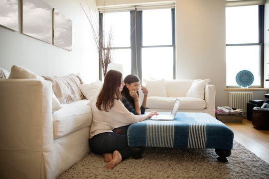 Two young women looking at laptop 