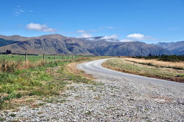 Rural/Country road winding through the stunning landscape of  the Otago Region in New Zealand's South Island. 