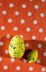 Yellow easter eggs decoration on red background on dots