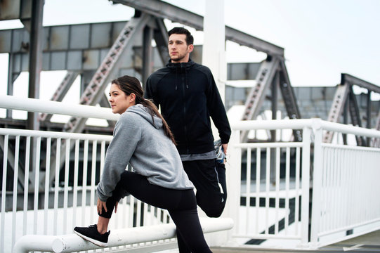Young people exercising on bridge 