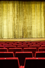 Theater interior. Yellow curtain. Red seats in theater interior. Vintage scene. Art performance....