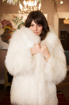 Portrait of young woman wearing fur coat  