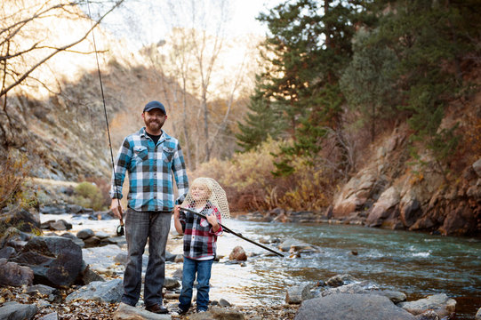 Father and son fishing in stream 