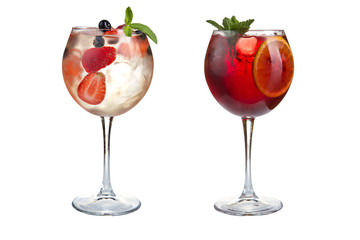 Two summer alcoholic or non-alcoholic cocktails with mint, fruits and berries on a white background. Cocktails in glass goblets.