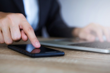 Fototapeta premium Closeup hand of business woman using smart mobile phone at office