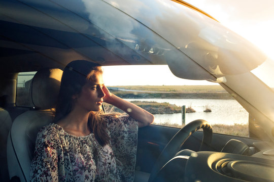 Young woman sitting at driver's seat 