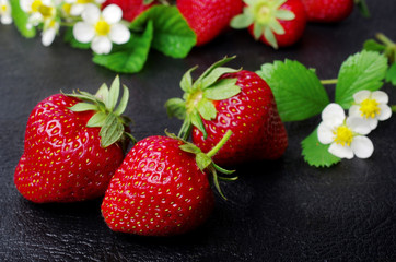 Ripe strawberries on a dark, close-up