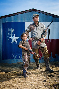 Portrait of father and daughter (6-7) hunting 