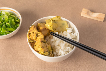 Bowl of rice and chicken with chinese cabbage, chopsticks - Japanese dish.