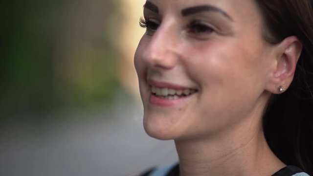beautiful young Caucasian woman drinking takeaway coffee on the street. Beautiful girl on the street with coffee smiling and enjoying. close-up