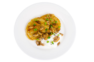 Plate with potato pancakes, fried mushrooms, isolated on white background.