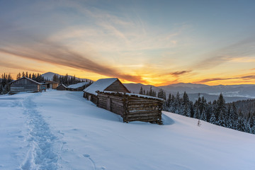 A colorful evening with a beautiful sunset and dusk in the snow-covered mountains of the mountains...