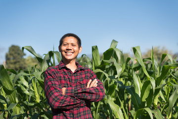 Portrait of Asian farmer smiling in corn field, Thailand