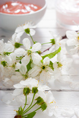 Naklejka na ściany i meble beauty products and cherry blossom on white wood table