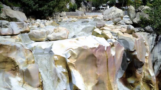 Surya Kund waterfall at Gangotri near Gangotri Temple, Himalayan Range Uttarakhand India.Pay obeisance to Sun God Waterfall Surya Kund on holy river Ganges on background mountain town Gangotri deodar.