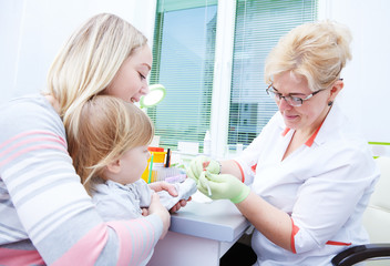 Obraz na płótnie Canvas Blood medical test or research. Taking a blood sample from child finger in hospital