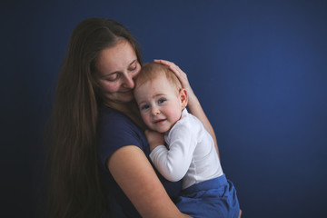 Mom and son baby together on blue background